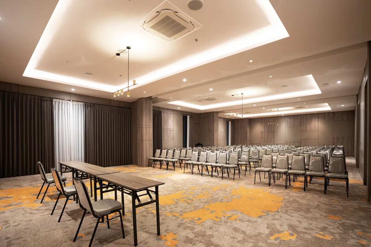 The ballroom set theatre at its full width, rows of chairs facing the head table.