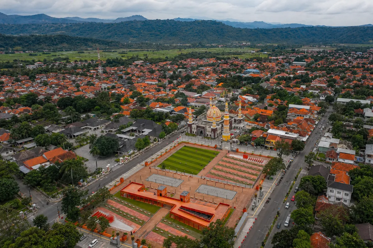 The Majalengka town square from above: a terracotta plaza and lawn with the yellow domes and minarets of the Grand Mosque at one end.